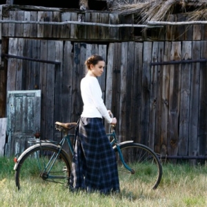 Fotografia mody, modelka przy rowerze na tle stodoły