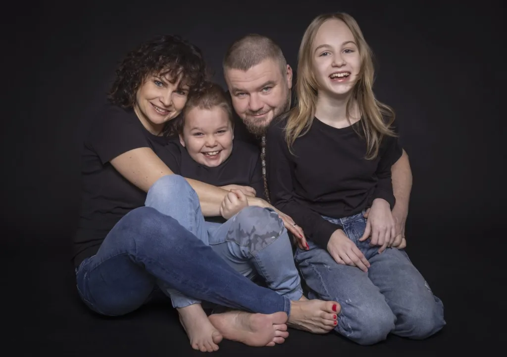 Rodzina siedząca razem na sesji w studiu